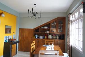 a dining room with a table and a chandelier at Monshing Homestay - Elevate your travel experience in Bomdila