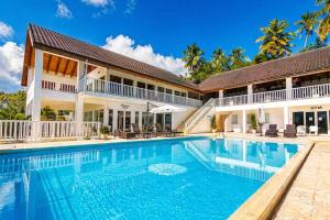 a large swimming pool in front of a house at Perfect Paradise, Oceanview in Samana in Santa Bárbara de Samaná