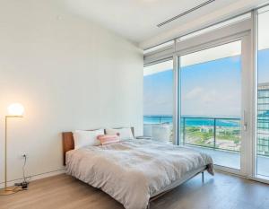 a bedroom with a bed and a large window at Sunset View Apartment Deluxe in Honolulu +29 photos