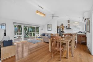 a kitchen and living room with a table and chairs at Foreshore - Spacious Metung Escape in Metung