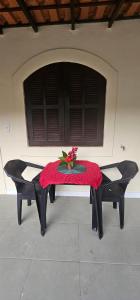 a table with a red table cloth on top at Pousada Paraíso Guapi in Guapimirim