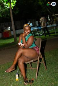 a woman sitting in a chair in the grass at RB Global Inc and RB Wizzy Ventures in Somanya