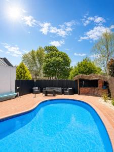 a swimming pool in the backyard of a house at Sundowner Motel in Blenheim +2 photos