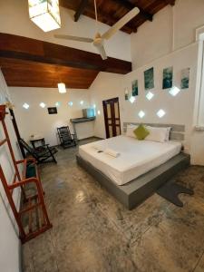a bedroom with a large bed in a room at Avalon Villa Unawatuna in Unawatuna