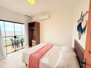 a bedroom with a bed and a view of the ocean at Roraimar Prime Maragogi - Beira Mar in Maragogi +137 photos