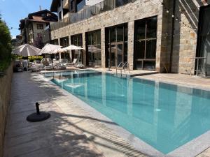 a large swimming pool in front of a building at Pirin Getaway Heaven in Razlog