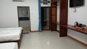 a room with a bed and a television in it at Romantic Vang Vieng resort in Vang Vieng