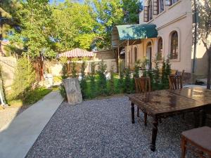 a table and chairs in front of a house at Ayvan Eco Hostel in Tashkent
