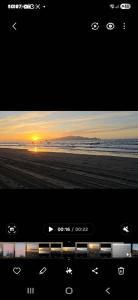 a television screen with a picture of the beach at Affordable pit stop Te Horo Beach in Te Horo
