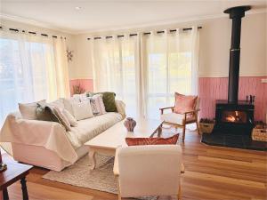 a living room with a couch and a fireplace at Shell Shack in Tomakin