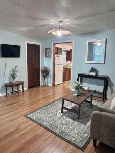 a living room with a couch and a table at Downtown 2 BR Cottage Close to IU in Bloomington