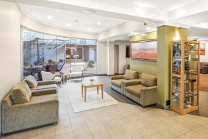 a living room with couches and a table at Mantra Alice Springs in Alice Springs
