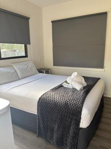 a bedroom with a bed with two towels on it at Bacchus Marsh Caravan Park in Bacchus Marsh