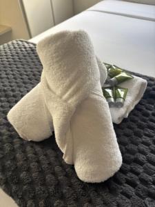 a white towel stuffed animal sitting on a bed at Bacchus Marsh Caravan Park in Bacchus Marsh