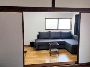 a living room with a couch and a table at 御宿空蝉 in Tokyo