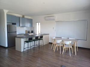 a kitchen with a table and chairs and a counter at Stunning sea views & golf course in Penneshaw