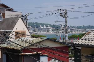 a group of roofs with a view of a harbor at 江ノ島の島内で一棟貸し一日一組限定はまさき旅館 in Fujisawa