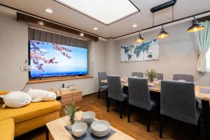 a dining room with a table and a large screen at HOTEL CtrlD ASAGAYA Spacious 130 Square Meter Apartment 4 Bedrooms 7 Beds 3 Minute Walk from JR Asagaya Station in Tokyo