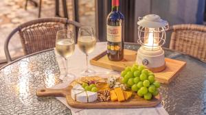 a table with two glasses of wine and a plate of food at Sokcho Jaja Ocean View Pension in Sokcho +6 photos