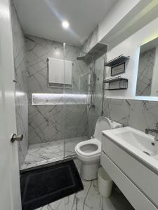 a white bathroom with a toilet and a sink at Deluxe two 2 bedroom in Priory +24 photos