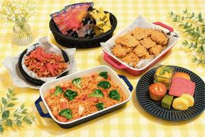 a table with bowls of food and plates of food at Hotel Trad Hakata in Fukuoka
