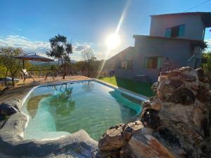 a swimming pool in front of a house at Casa mussambé in Sao Jorge