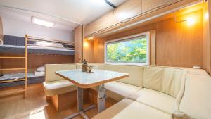 a small room with a table and a bench at gyeongju yongcheonsu caravan in Gyeongju