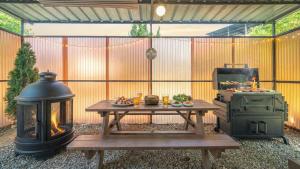 a patio with a grill and a table with a stove at gyeongju yongcheonsu caravan in Gyeongju
