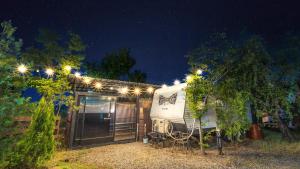 an rv parked in front of a house at night at gyeongju yongcheonsu caravan in Gyeongju