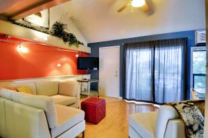 a living room with two white couches and a tv at Barton Hills Condominiums in Austin