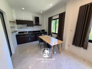 a kitchen with a wooden table in a room at Coco Villa in Hinkong