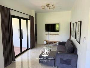 a living room with a couch and a tv at Coco Villa in Hinkong