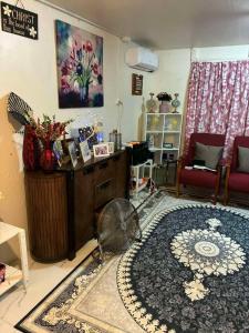 a living room with a large rug on the floor at Raiwai Cozy Corner in Suva