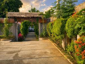 an entrance to a garden with an arch and flowers at Pondok DlodPoh in Karangasem +12 photos