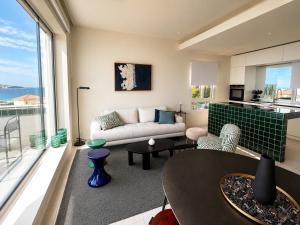 a living room with a couch and a table at New - sea view - splendid apartment in Nice