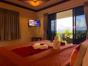 a hotel room with a bed with towels on it at Infinity Heights Resort in Siquijor