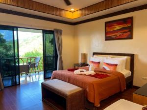 a bedroom with a bed and a balcony at Infinity Heights Resort in Siquijor +81 photos
