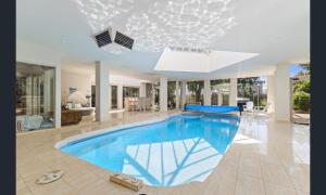 a large swimming pool in a house with at Sarovar Holidays in Traralgon