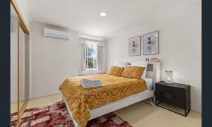 a bedroom with a bed and a window at Sarovar Holidays in Traralgon +28 photos