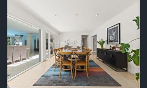 a dining room and kitchen with a table and chairs at Sarovar Holidays in Traralgon