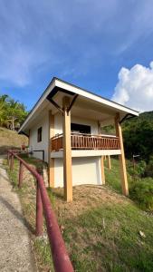 a house with a balcony on the side of it at Infinity Heights Resort in Siquijor
