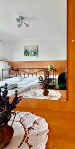 a bedroom with a bed and a table with a mirror at Na Snozie in Milówka