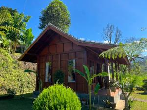 a small house in the middle of a garden at Pondok Kayu Pathavi in Baturiti +16 photos