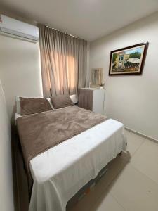 a bedroom with a large bed in front of a window at Flat Carneiros - Hotel Marinas in Tamandaré