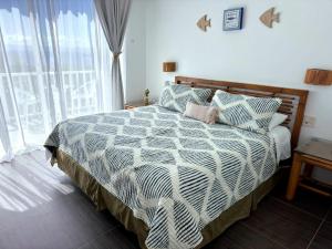 a bedroom with a bed and a large window at Perfect Paradise, Oceanview in Samana in Santa Bárbara de Samaná