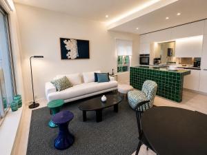 a living room with a couch and a table at New - sea view - splendid apartment in Nice
