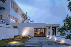 an exterior view of a building with a walkway at Zhiye Resort Hotel in Guanling