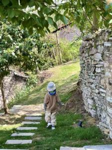 a young boy walking down a stone path at Zhiye Resort Hotel in Guanling