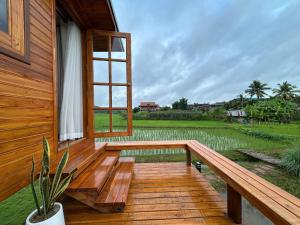 a porch of a wooden house with a window at Nonnatatonview นอนนาตาทนวิว in Phayao