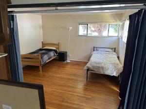a bedroom with two beds and a window at 4 Room Sleeps 8plus Tranquil Home in Santa Cruz